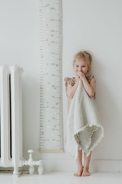 Échelle de croissance – Marguerites sur fond beige